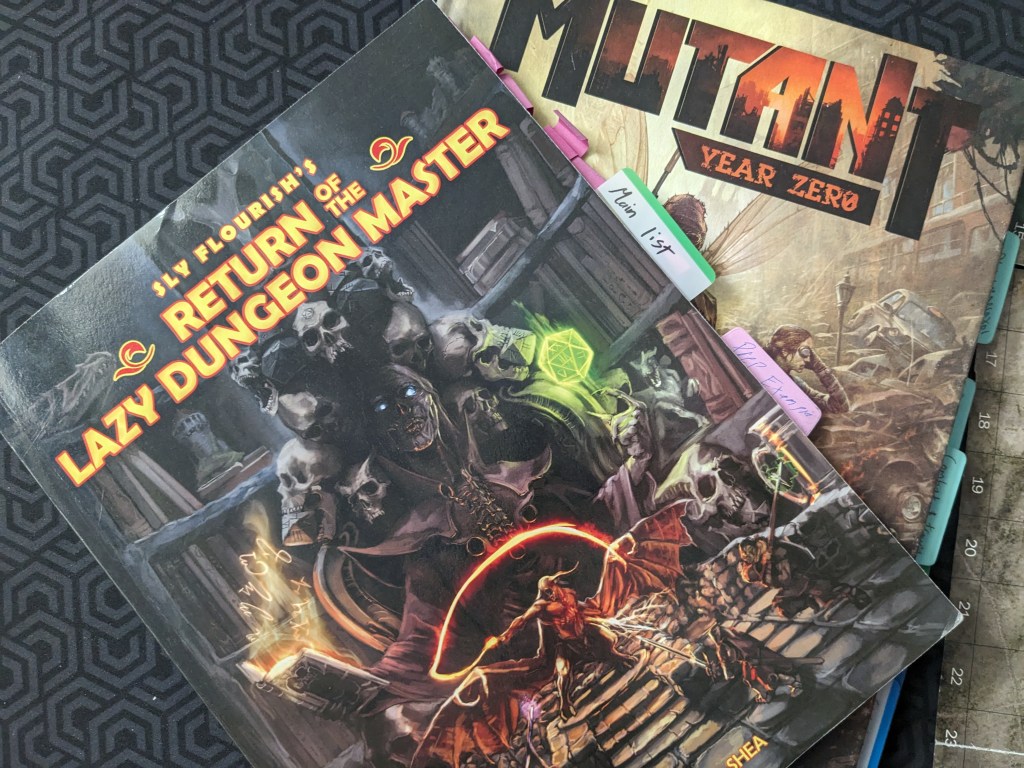 A heavily bookmarked copy of Sly Flourish on top of a heavily bookmarked copy of Mutant Year Zero 